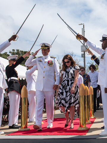 A U.S. Navy Captain during a retirement ceremony departs through side boys after turning over command.