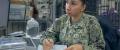 A United States Navy Logistics Specialist maintains logs and records in a Navy Post Office.