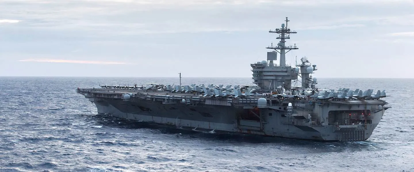 The USS Theodore Roosevelt aircraft carrier (CVN 71) sails through the open ocean.