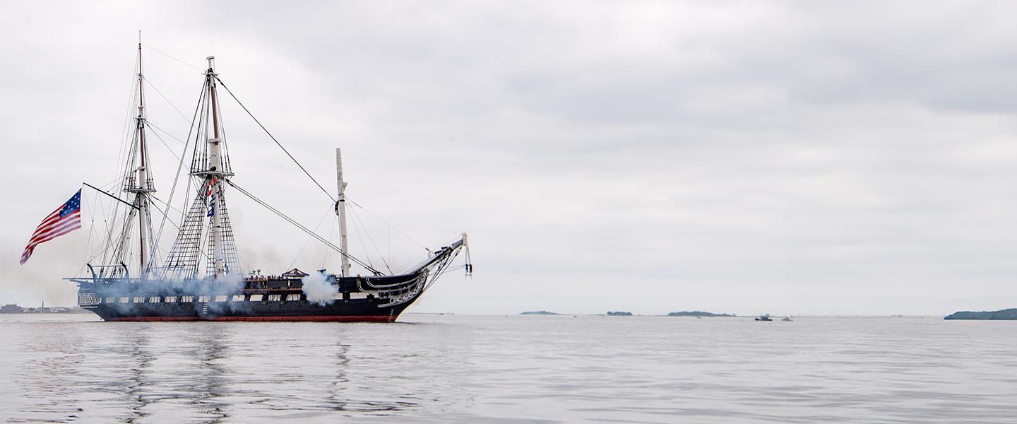 historic Naval vessel firing cannons
