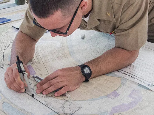 Navy Officer Candidate School candidates use navigation tools during a training exercise at Officer Training Command Newport.