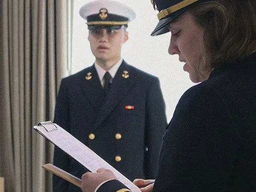 A naval officer quizzes an Officer Candidate School student during a personnel inspection at Officer Training Command Newport.