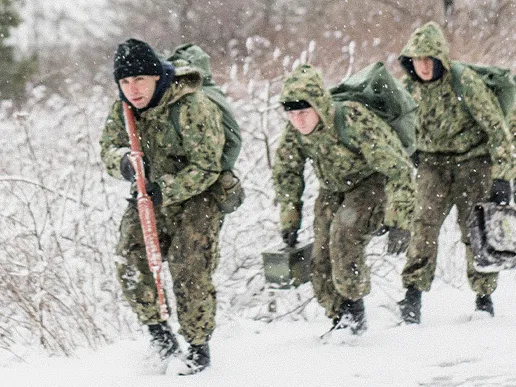 Navy Officer Candidate School students advance together during a battle stations training exercise at Officer Training Command Newport.