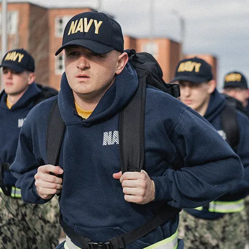 A group of Navy Officer Candidate School students travels together between training stations during a battle stations exercise.