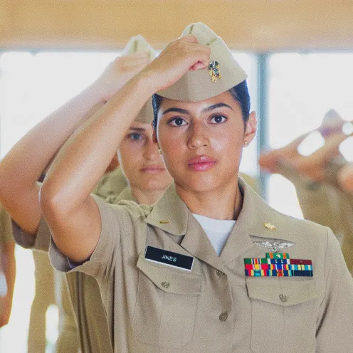 Navy Officer Development School students stand in formation while their service khaki uniforms are inspected at Officer Training Command Newport.